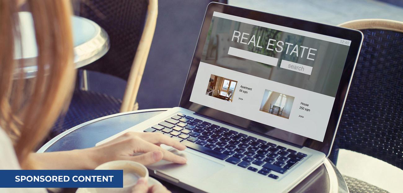 Woman looking at real estate website on laptop