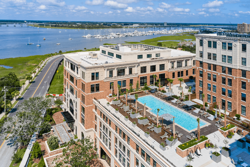 drone view of a rooftop pool in a brick condo building