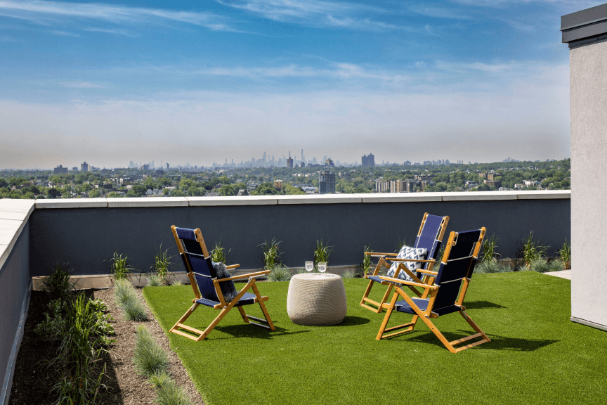 A rooftop seating area overlooking a city skyline