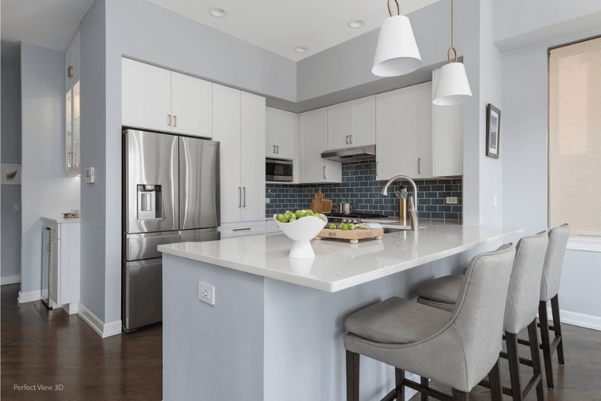 all white kitchen with stainless appliances and a small island