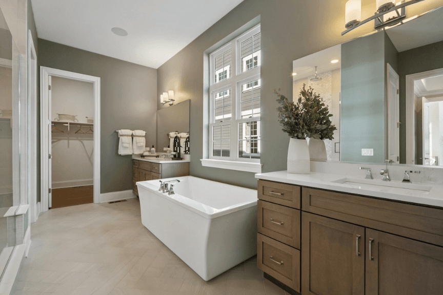 Modern farmhouse style bathroom with gray walls and stand alone bathtub