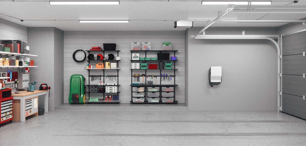 A clean, organized garage painted gray with an EV charger mounted to the wall