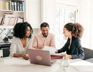 Real estate agent and clients at kitchen table