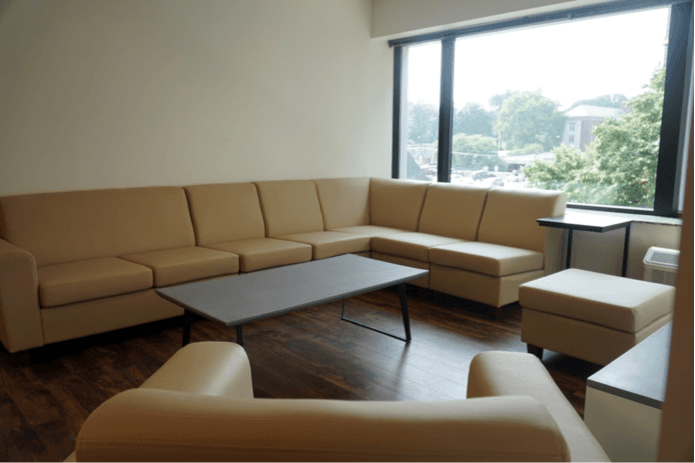 Plain beige couches in a dorm room 