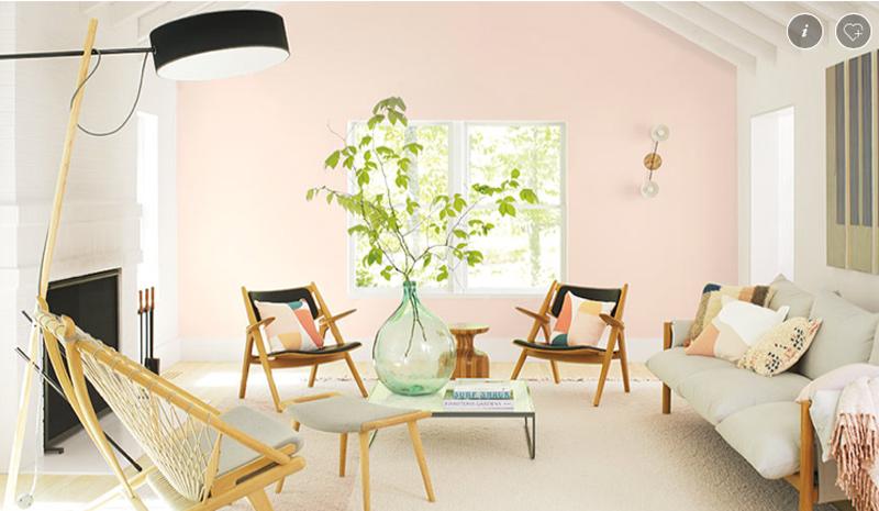 A Living room with white carpet and rose "blush" colored accent wall. 