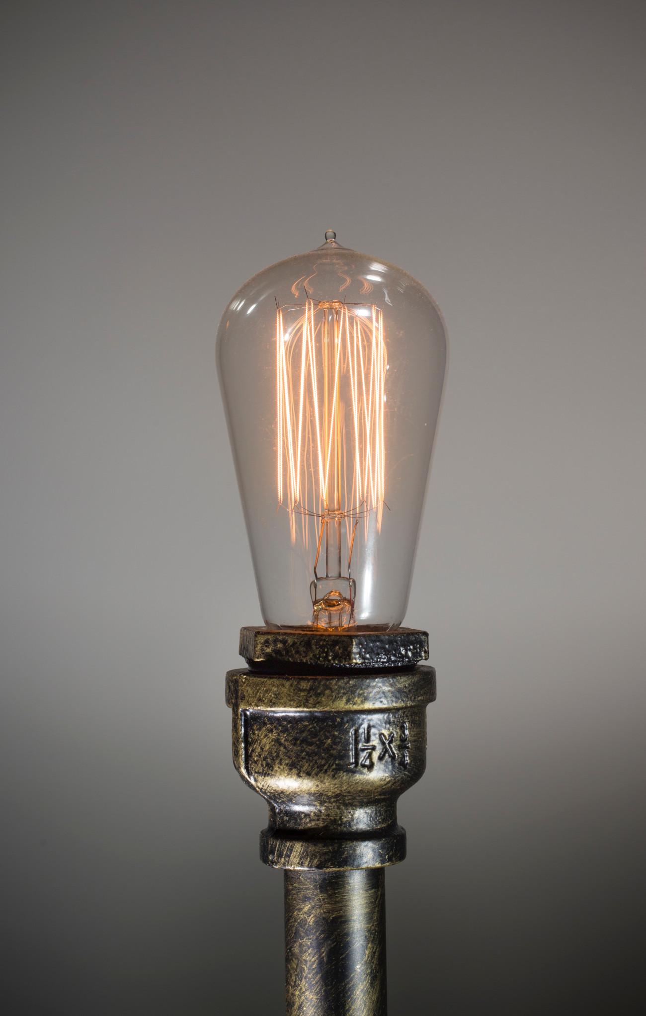 An edison lightbulb on a pipe lamp