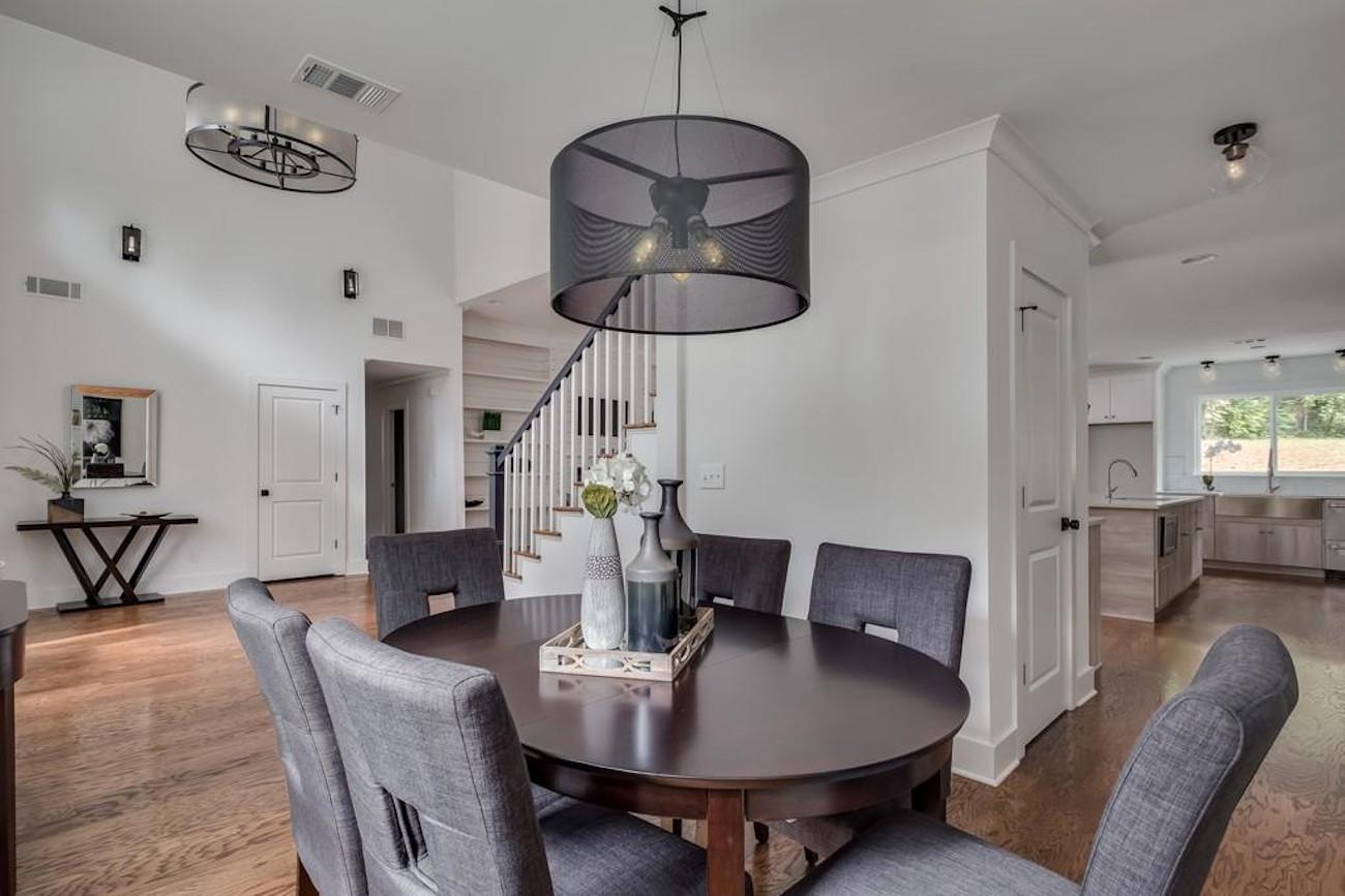 Dining room with gray vases in the center of the table used as home staging props