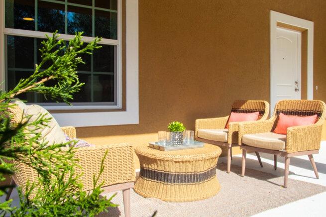 Outside patio with wicker furniture. 