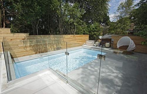 A modern pool with a glass enclosed overlook