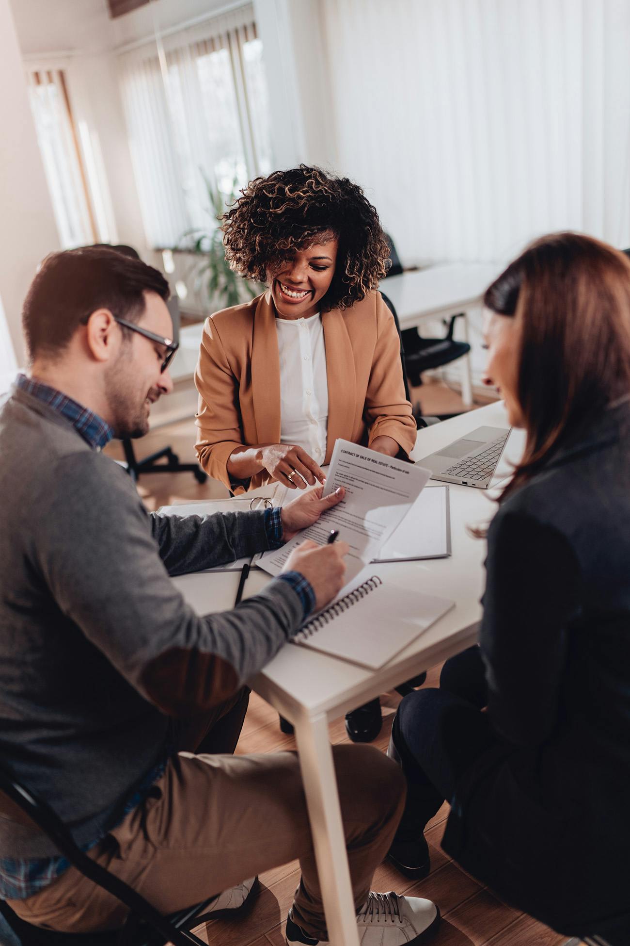 Agent and clients signing papers