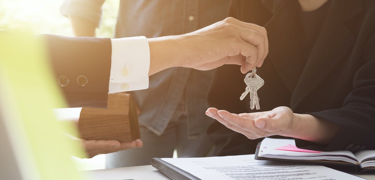 Handing keys to clients after signing paperwork.