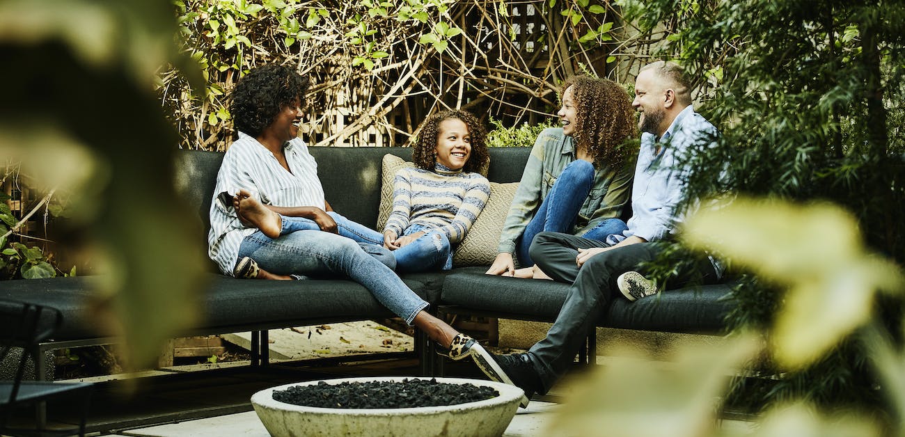 Family of four sitting on outdoor patio.