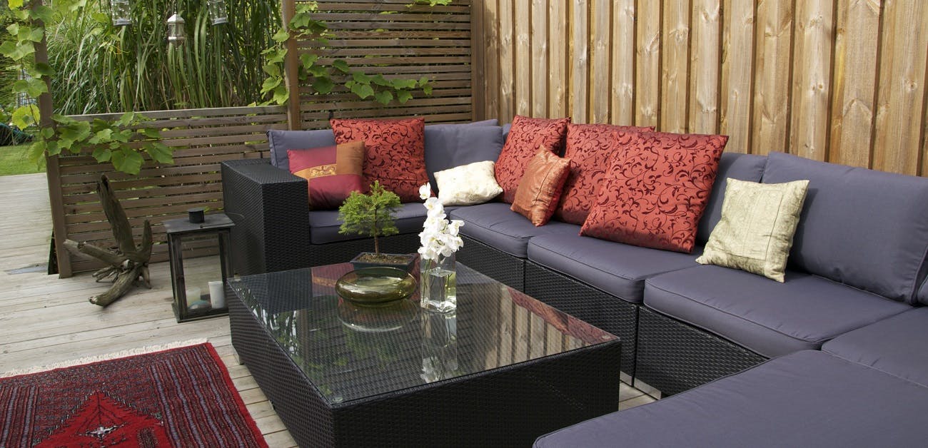 Contemporary patio with large wicker sofa