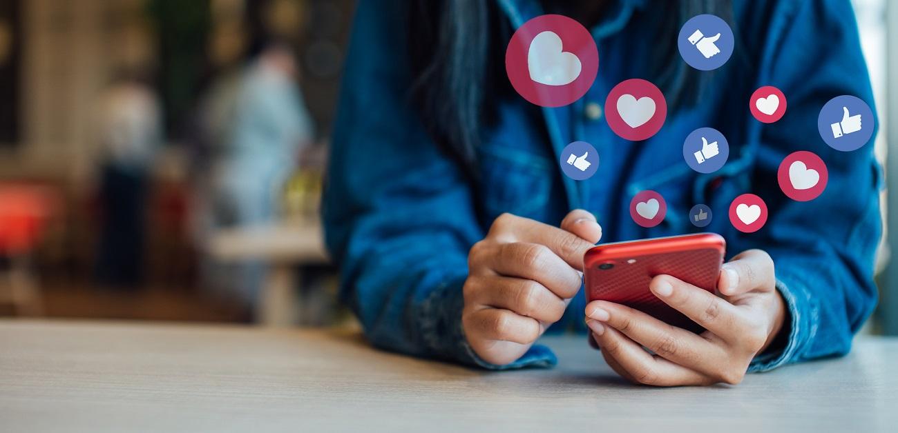 Woman Using Smart Phone On Table