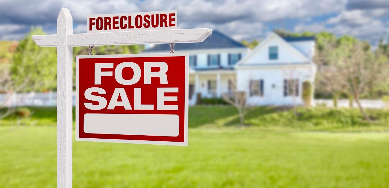 Foreclosure Home For Sale Sign in Front of Large House