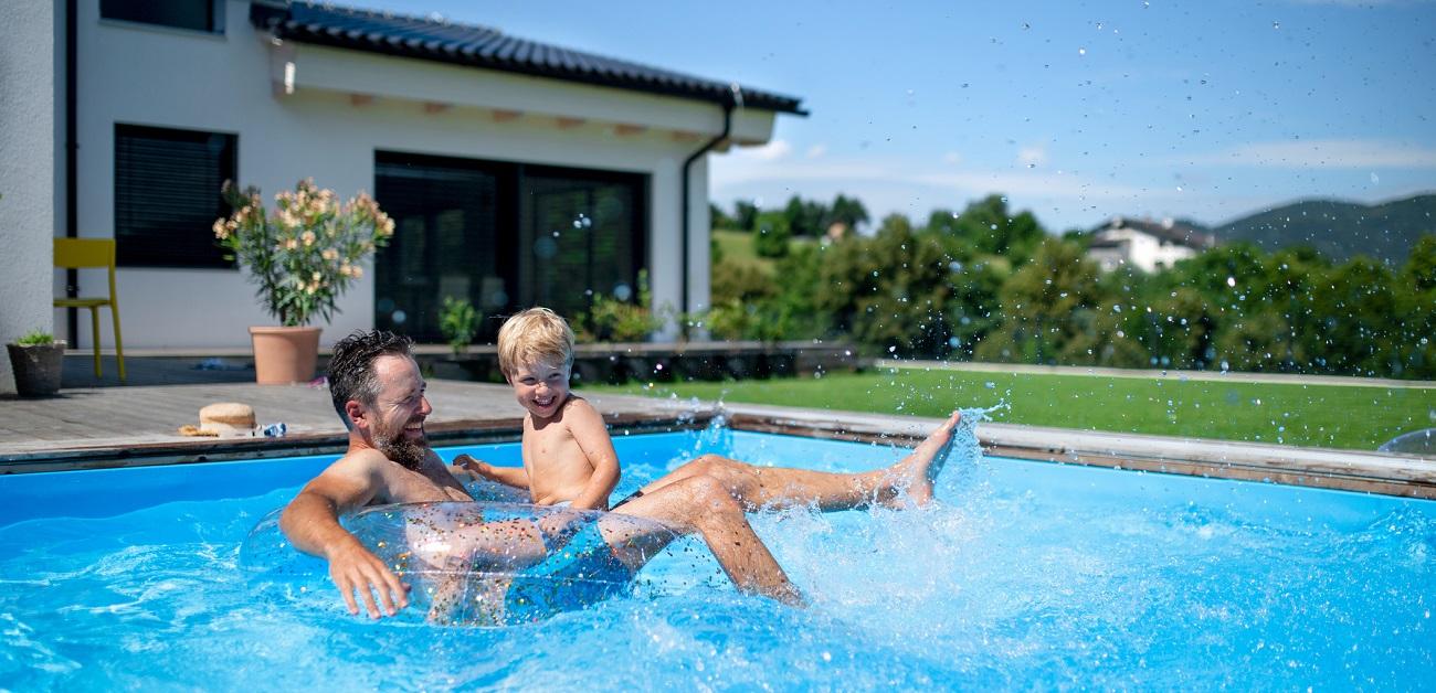 Father and son playing in swimming pool