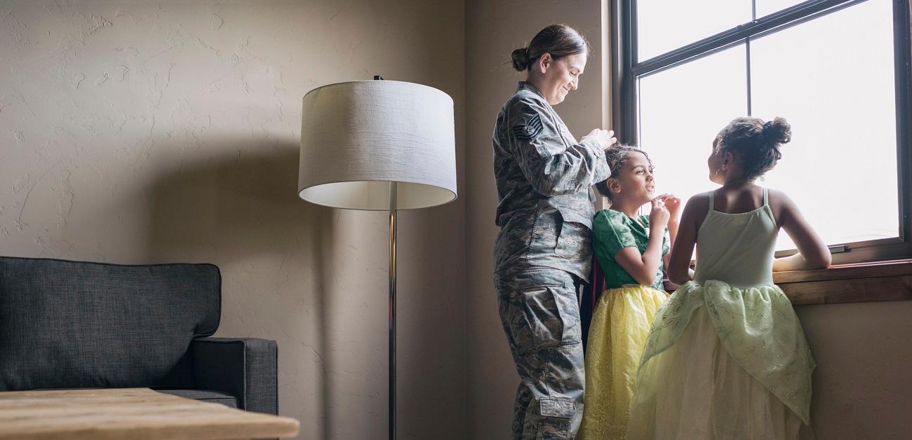 Mother in military uniform with twin daughters