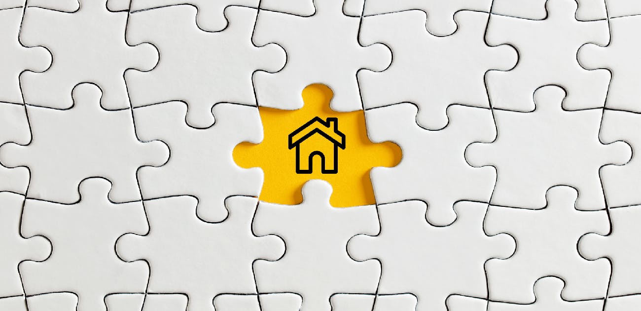 A picture of a puzzle with all blank white pieces, and the one remaining opening shows an icon of a house on a yellow background