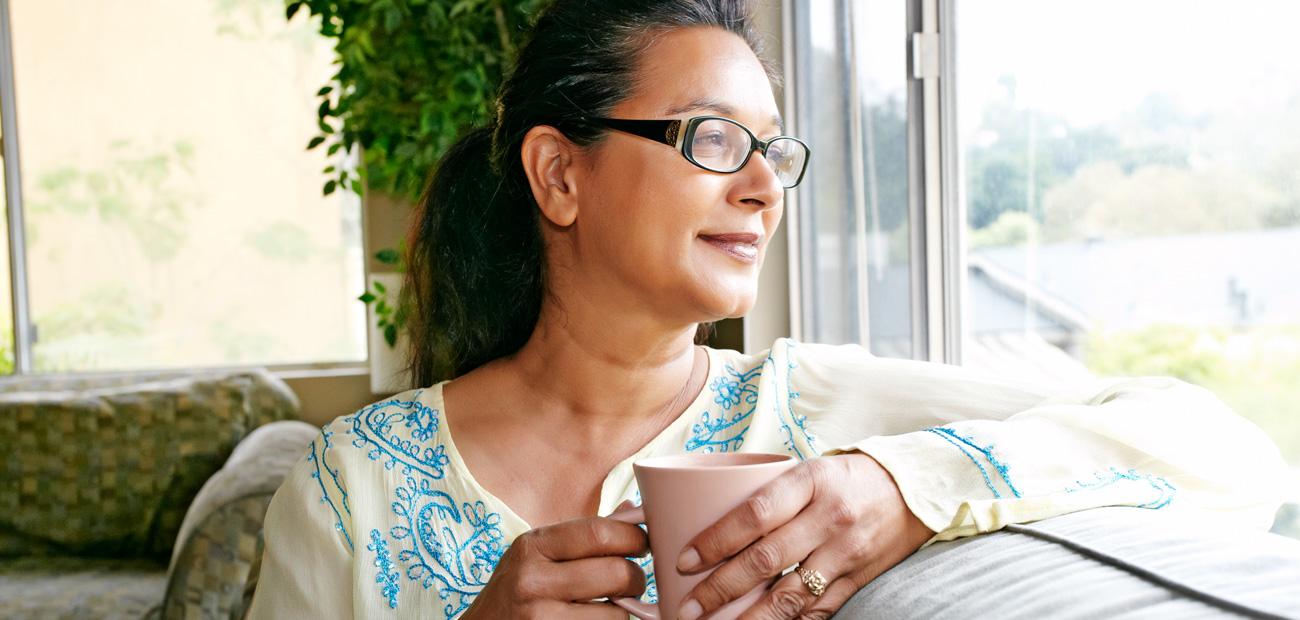 Woman having coffee at home