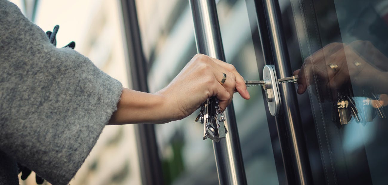 woman unlocking door