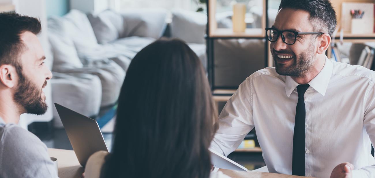 couple signing paperwork at home