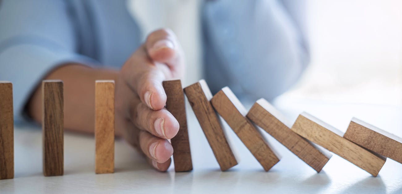 stopping tumbling dominos