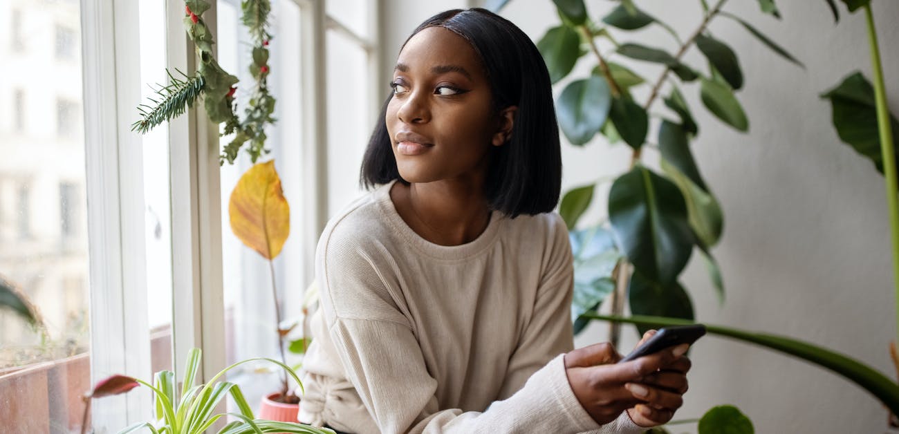 Woman at home looking outside window