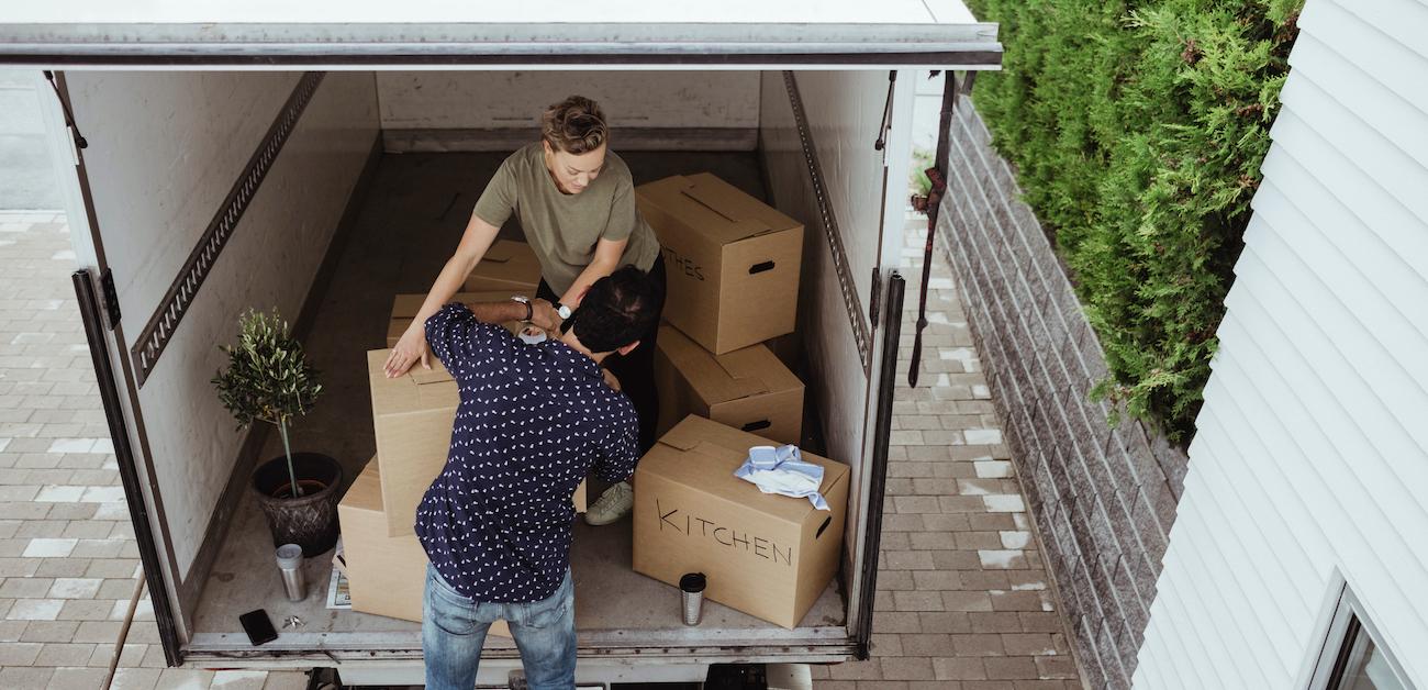 Couple loading boxes in moving truck