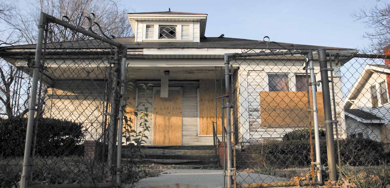 Vacant, boarded up house.