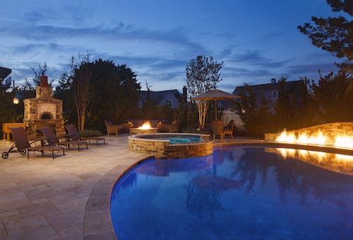 Backyard pool with fire pit and accents