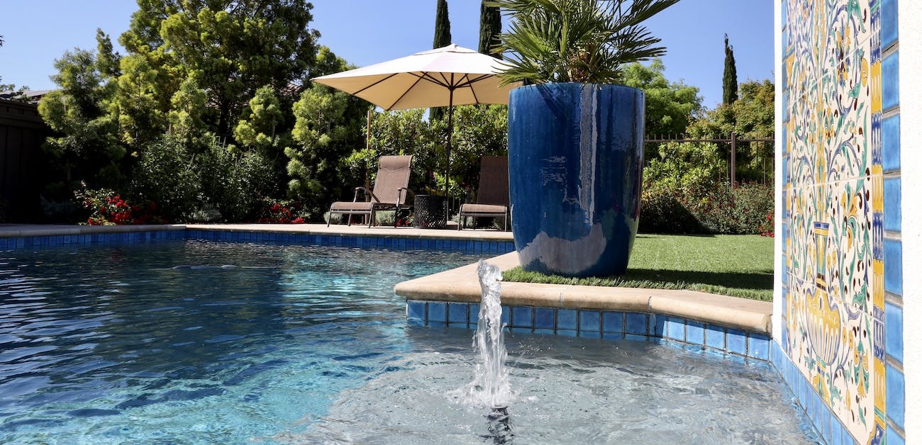 Pool with fountain and tile embellishments.