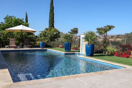 Rectangular backyard pool with umbrella