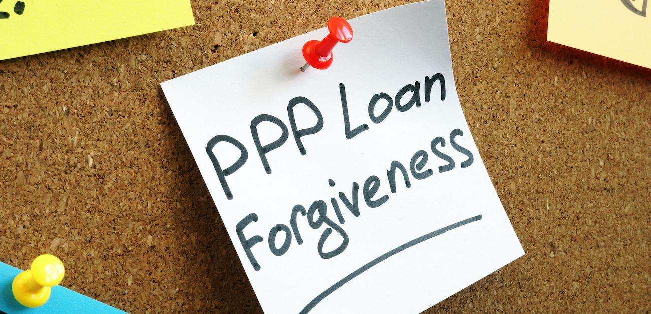 PPP loan forgiveness note on corkboard