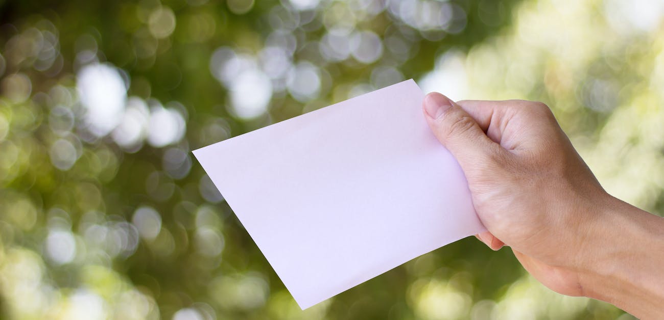 Man holding up a letter