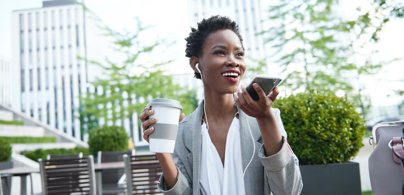 Businesswoman talking on phone at outdoor cafe