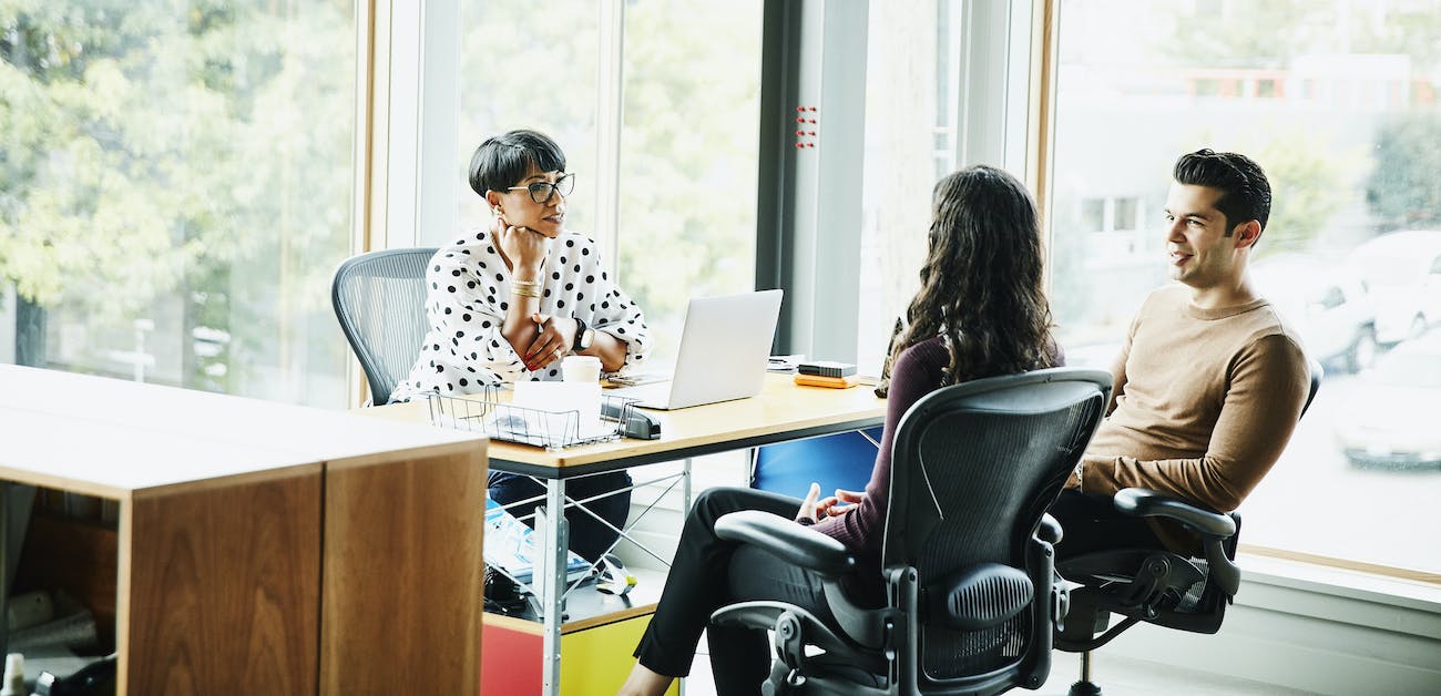 Discussion with clients seated at office desk