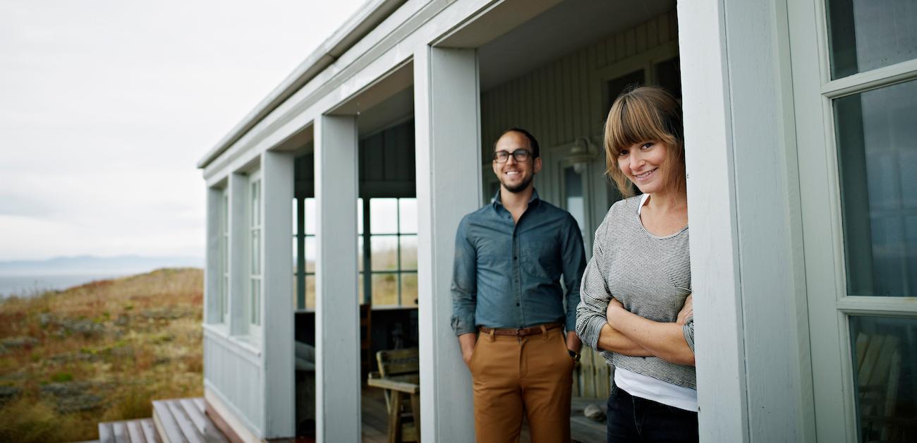 Couple standing in their coastal vacation property