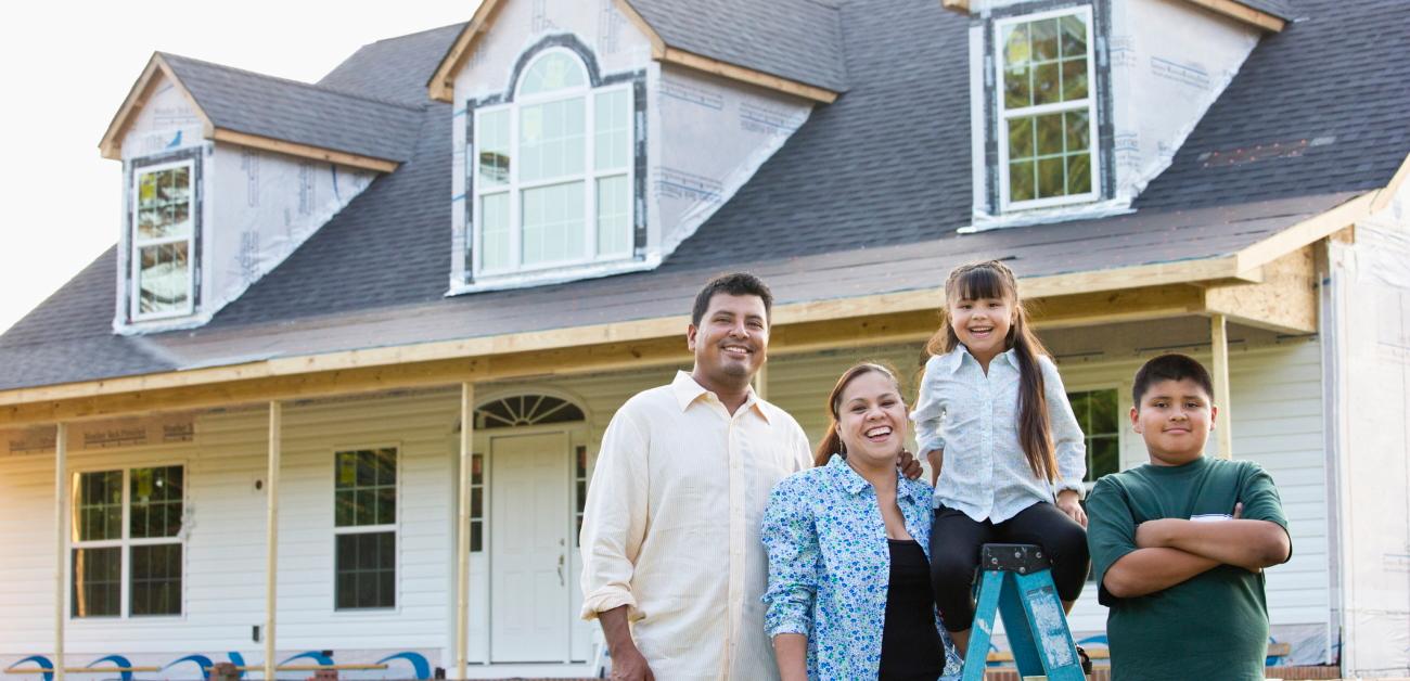 A Hispanic family in front of a home