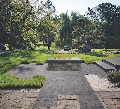 Tree-lined backyard with fire table