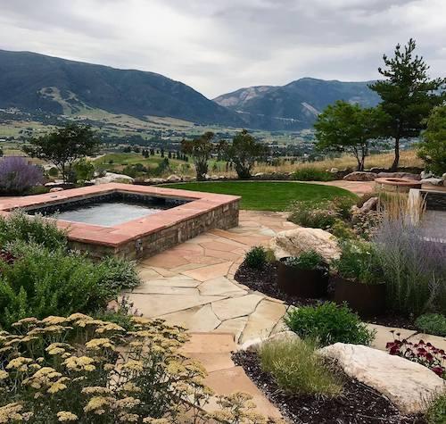 Backyard with hot tub, hardscape, and garden