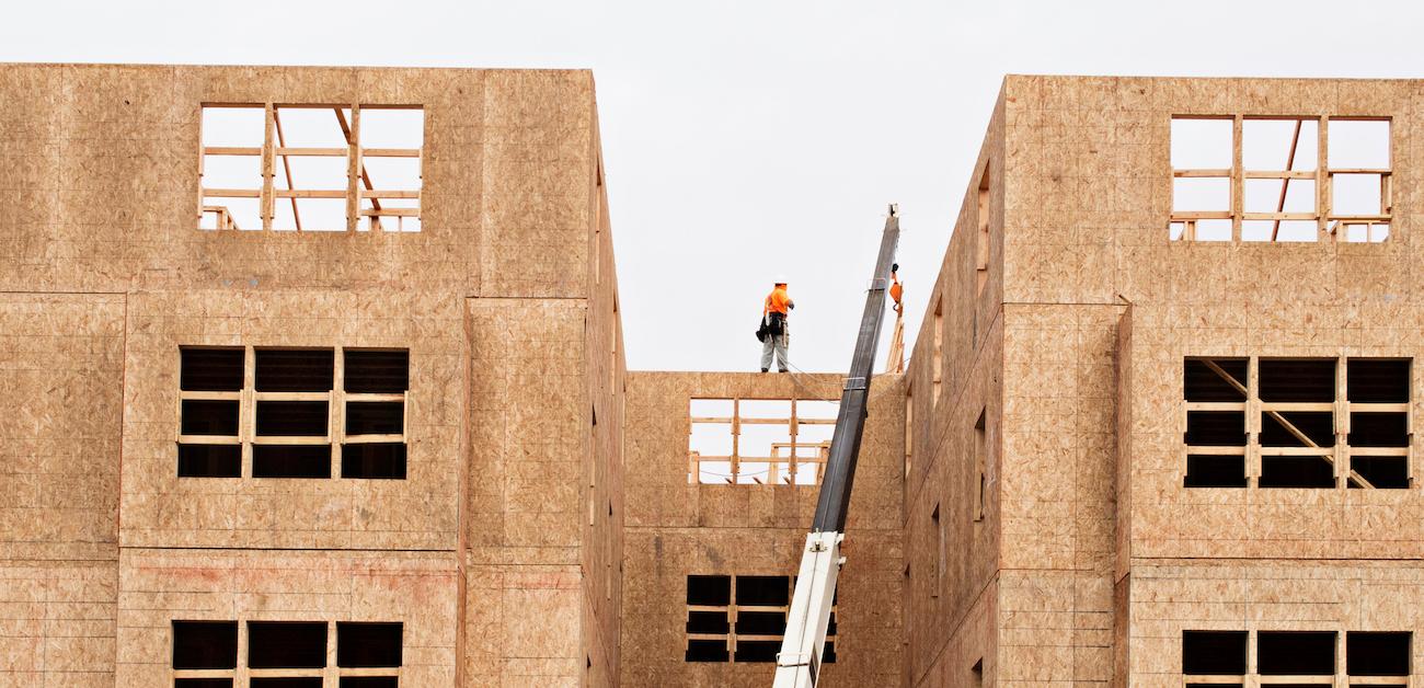 Workers on top of condo building under construction