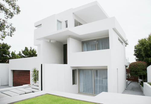 A modern white house with brown garage door