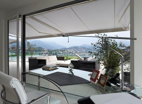 interior of modern home with a large, open glass door leading to outdoor space