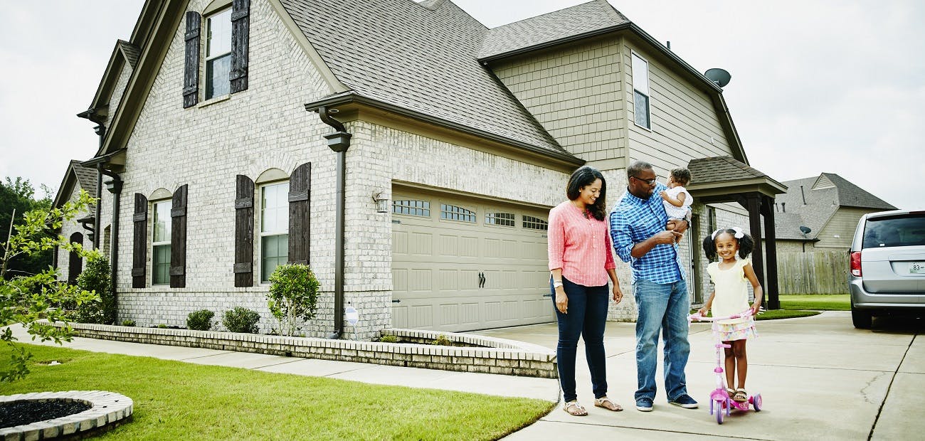 Family in front of house