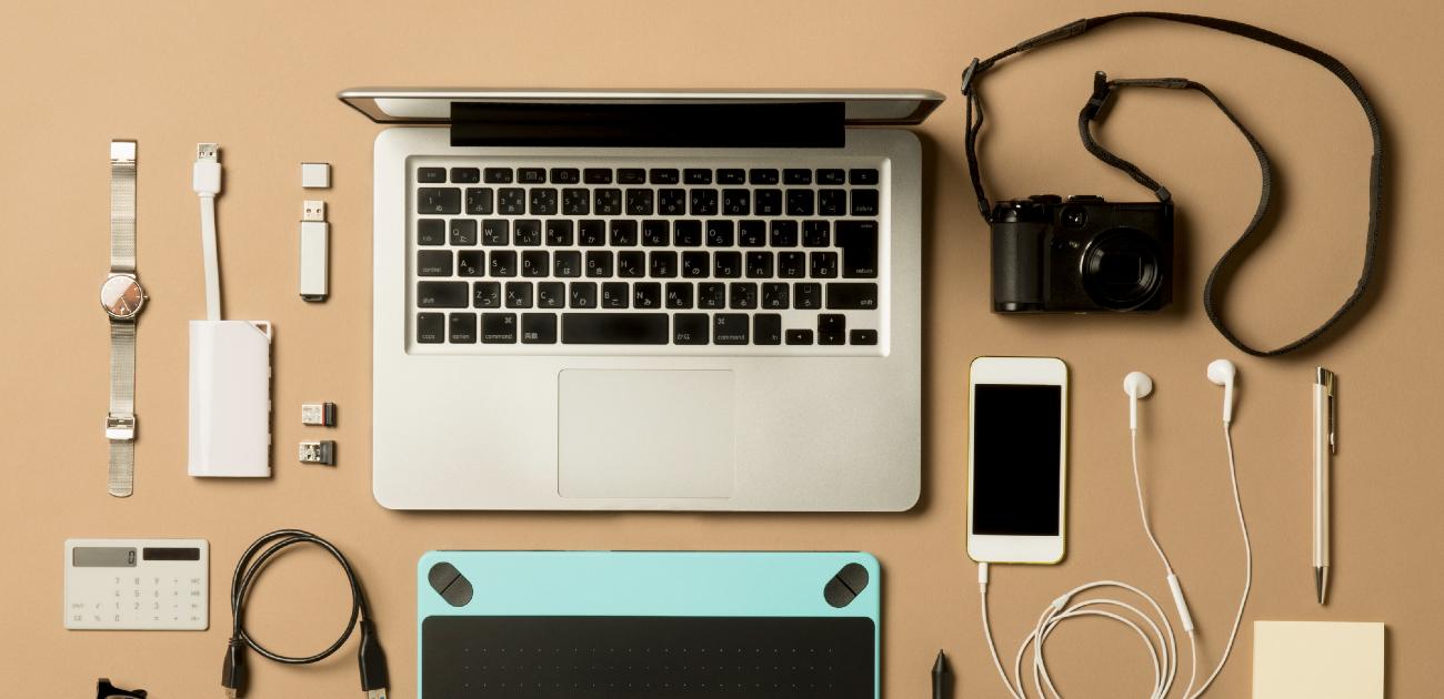 A picture looking straight down at various electronic gadgets spread out on a desk.