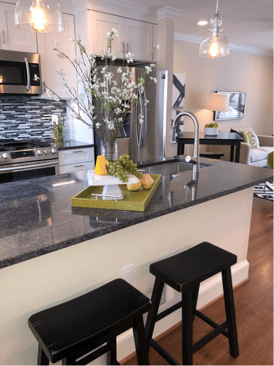 Bright kitchen staged with greenery for summer