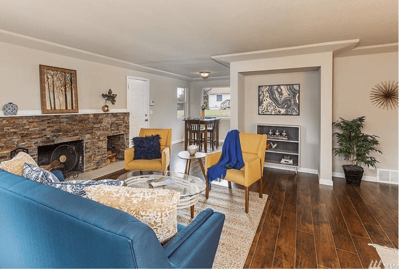 a bright living room with yellow chairs