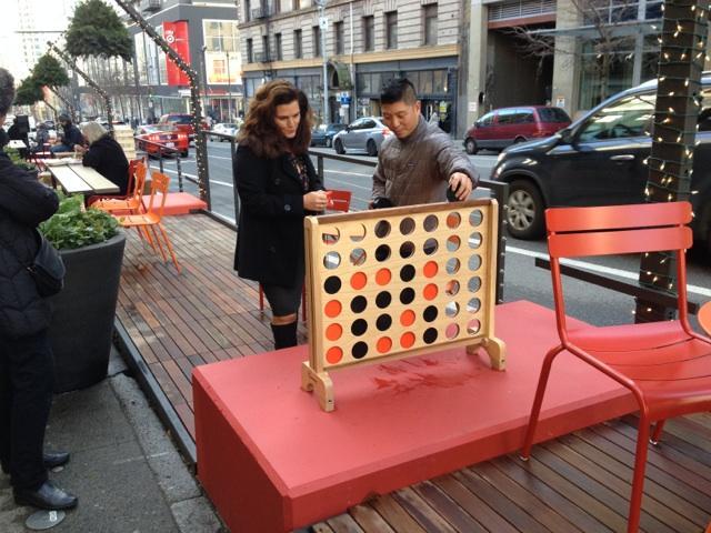 The Chromer Building parklet in downtown Seattle converted five on-street parking spaces into the city’s biggest parklet. Its December opening included games and live music. (Credit: Seattle Department of Transportation)