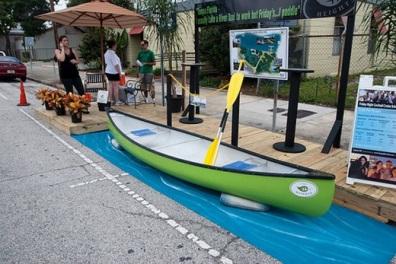 A kayak exhibit set up inside a parklet