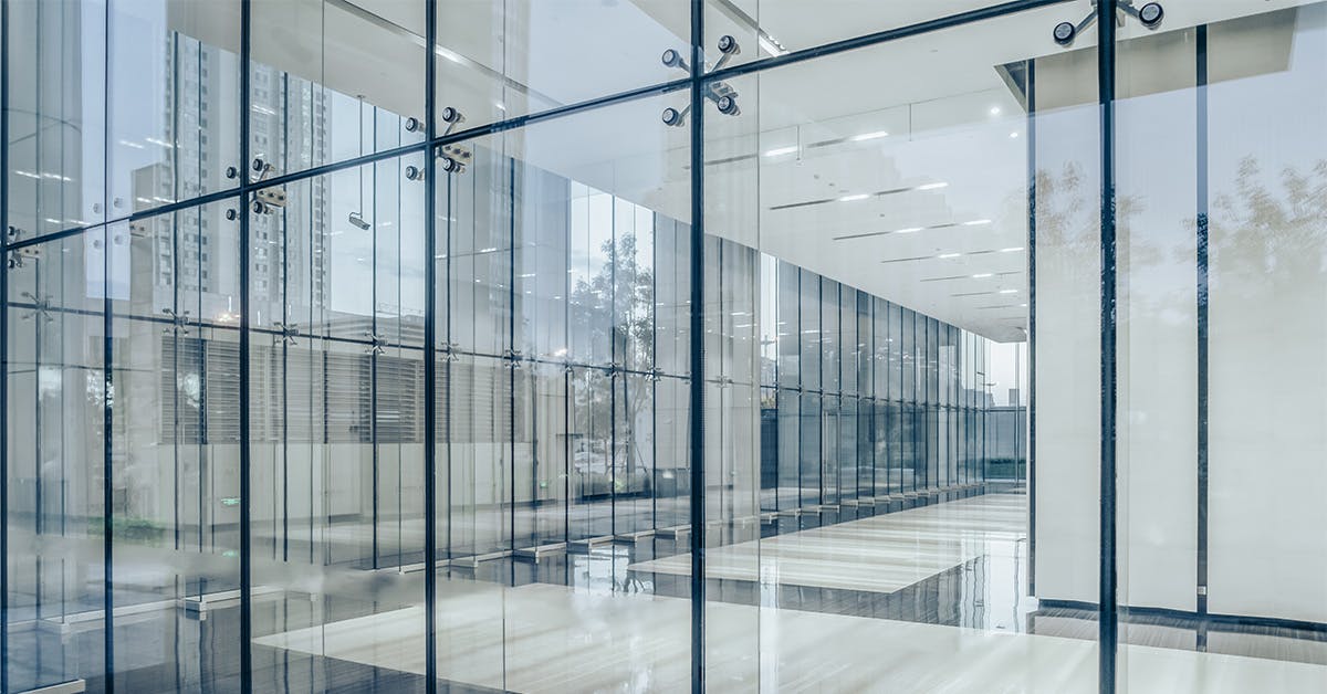 Commercial building corridor seen through glass walls